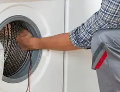 Dryer repair technician diagnosing and servicing a clothes dryer in Bradenton, FL