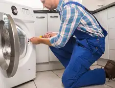 Washing machine repair technician servicing a front-load washer in Bradenton, FL